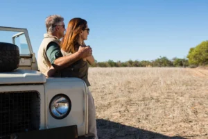 Couple enjoying a safari view from a jeep in Serengeti National Park during a wildlife tour Serengeti Safari Cost